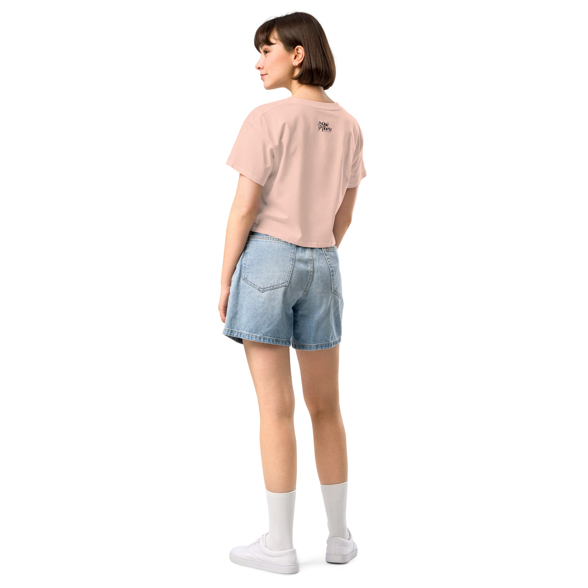 Person wearing a light pink t-shirt and denim shorts on a white background