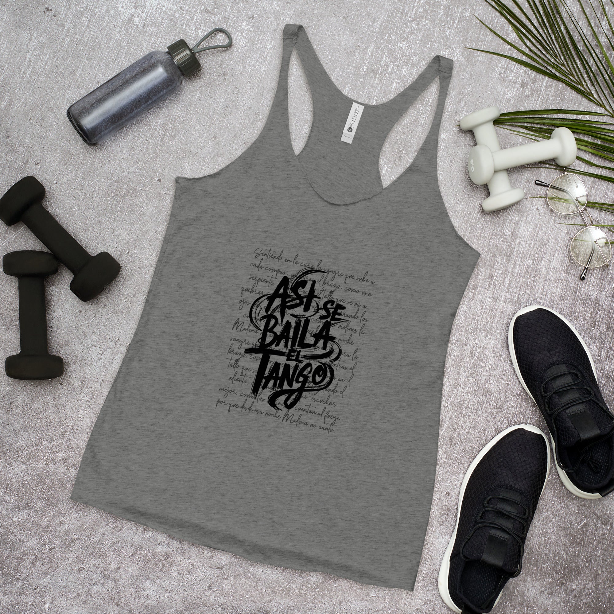 Gray tank top with black text on a gray surface with fitness items