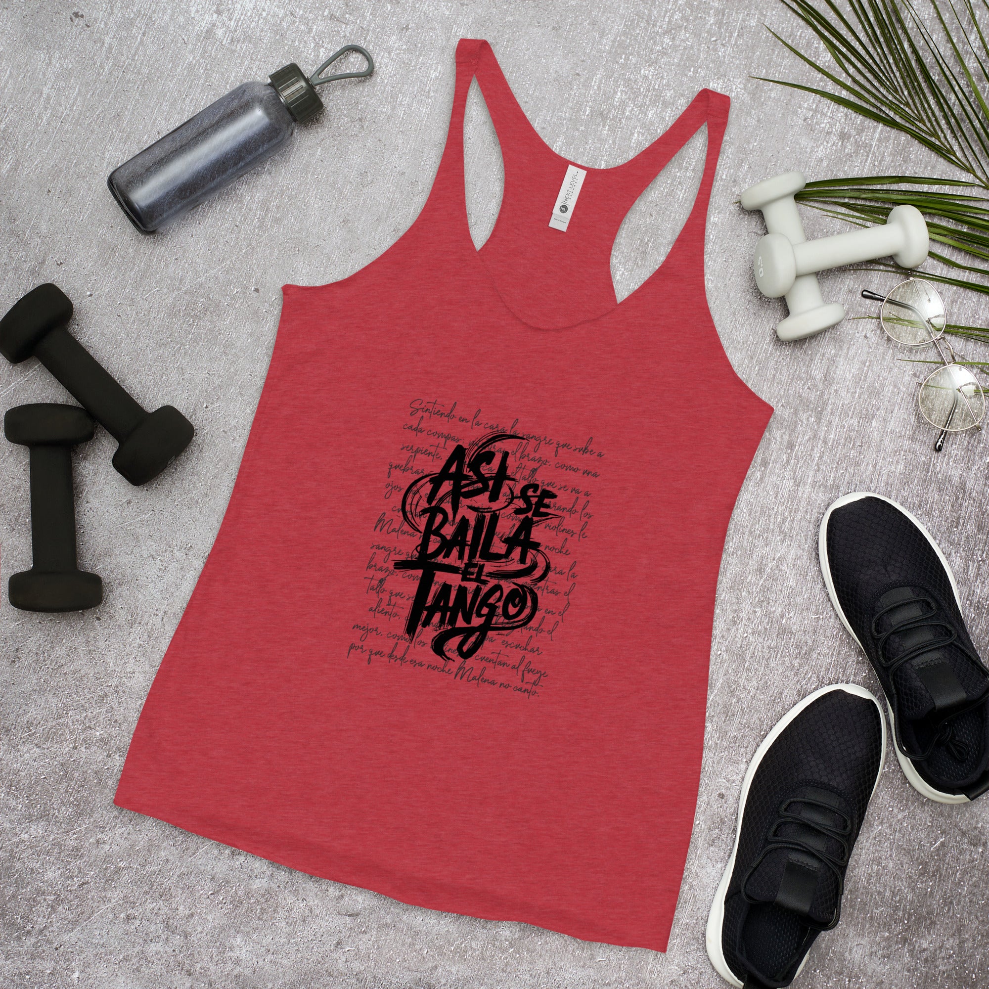 Red tank top with black text on a gray surface with fitness items.