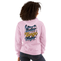 Person wearing a pink sweatshirt with colorful text on the back, standing against a white background