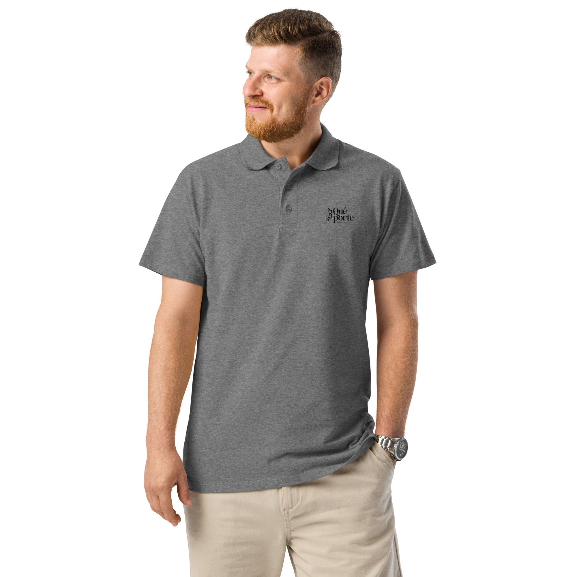 Man wearing a gray polo shirt with a logo on a white background