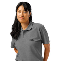Woman wearing a gray polo shirt with a logo on a white background