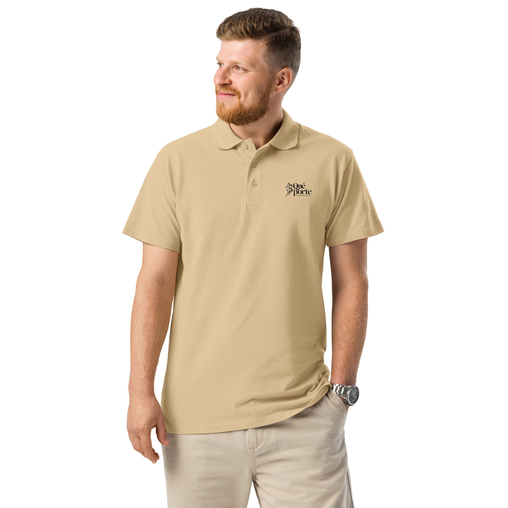 Man wearing a beige polo shirt with a logo on a white background
