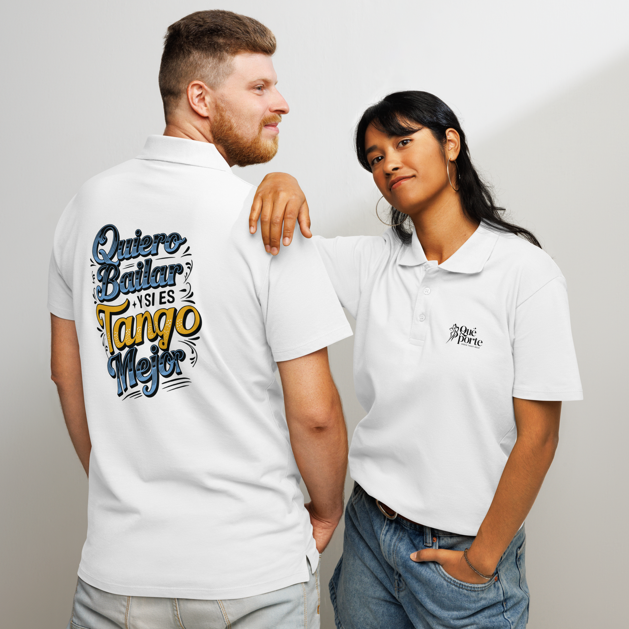 Two people wearing white polo shirts with text and logos on a plain background