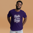 Man wearing a purple t-shirt with Spanish text on a brown background