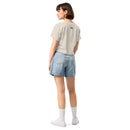 Person wearing a beige t-shirt and denim shorts on a white background