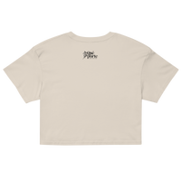 Beige crop top with a brand logo on the back against a white background