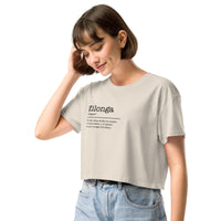 Woman wearing a beige t-shirt with text on a white background