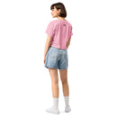 Person wearing a pink t-shirt and denim shorts on a white background