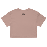 Pink crop top with a brand logo on the back against a white background