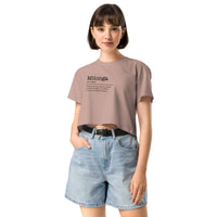 Woman wearing a beige t-shirt with text and denim shorts on a white background