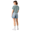 Person wearing a light green t-shirt and denim shorts on a white background