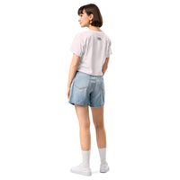 Person wearing a white t-shirt and denim shorts on a white background