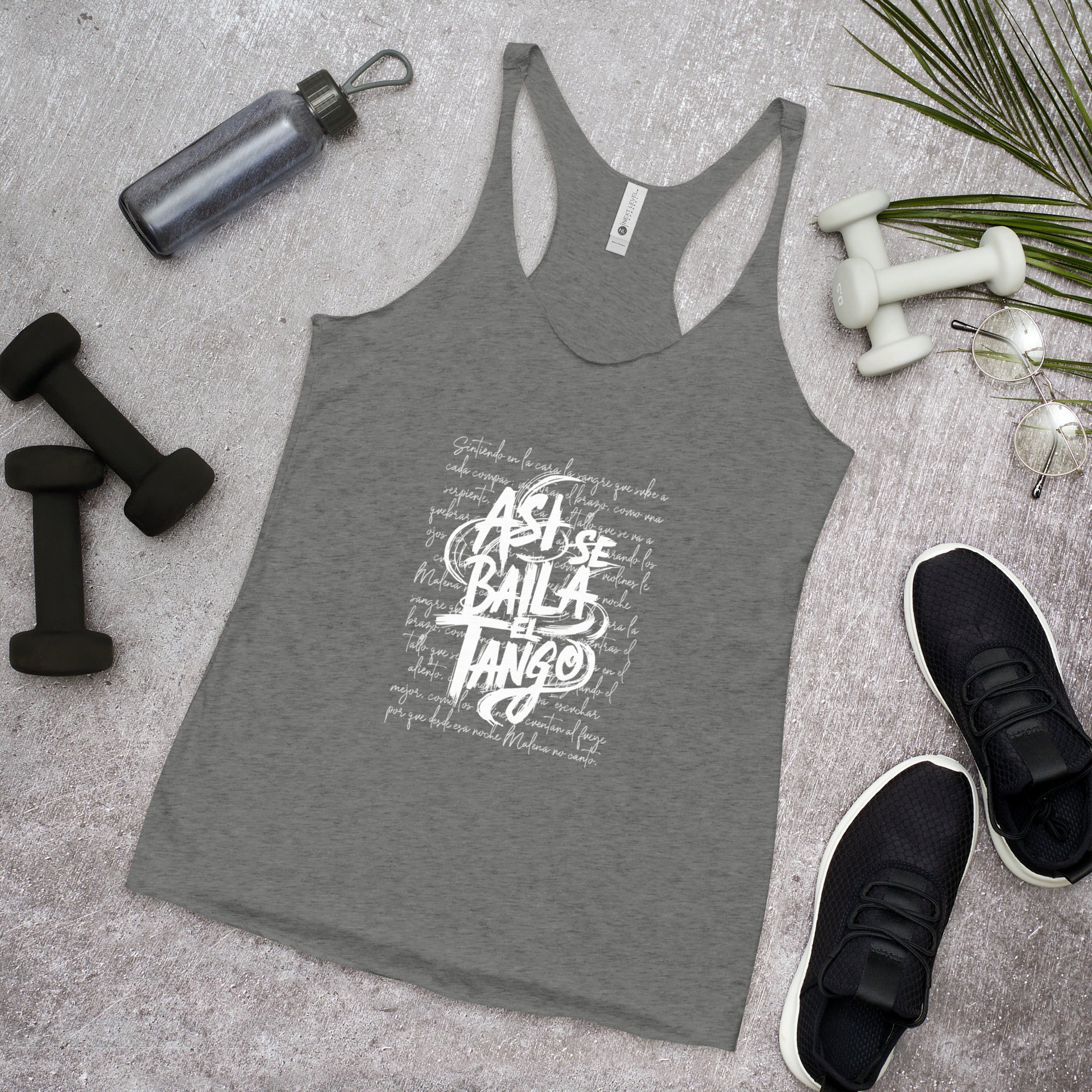 Gray tank top with white text on a gray surface with fitness items