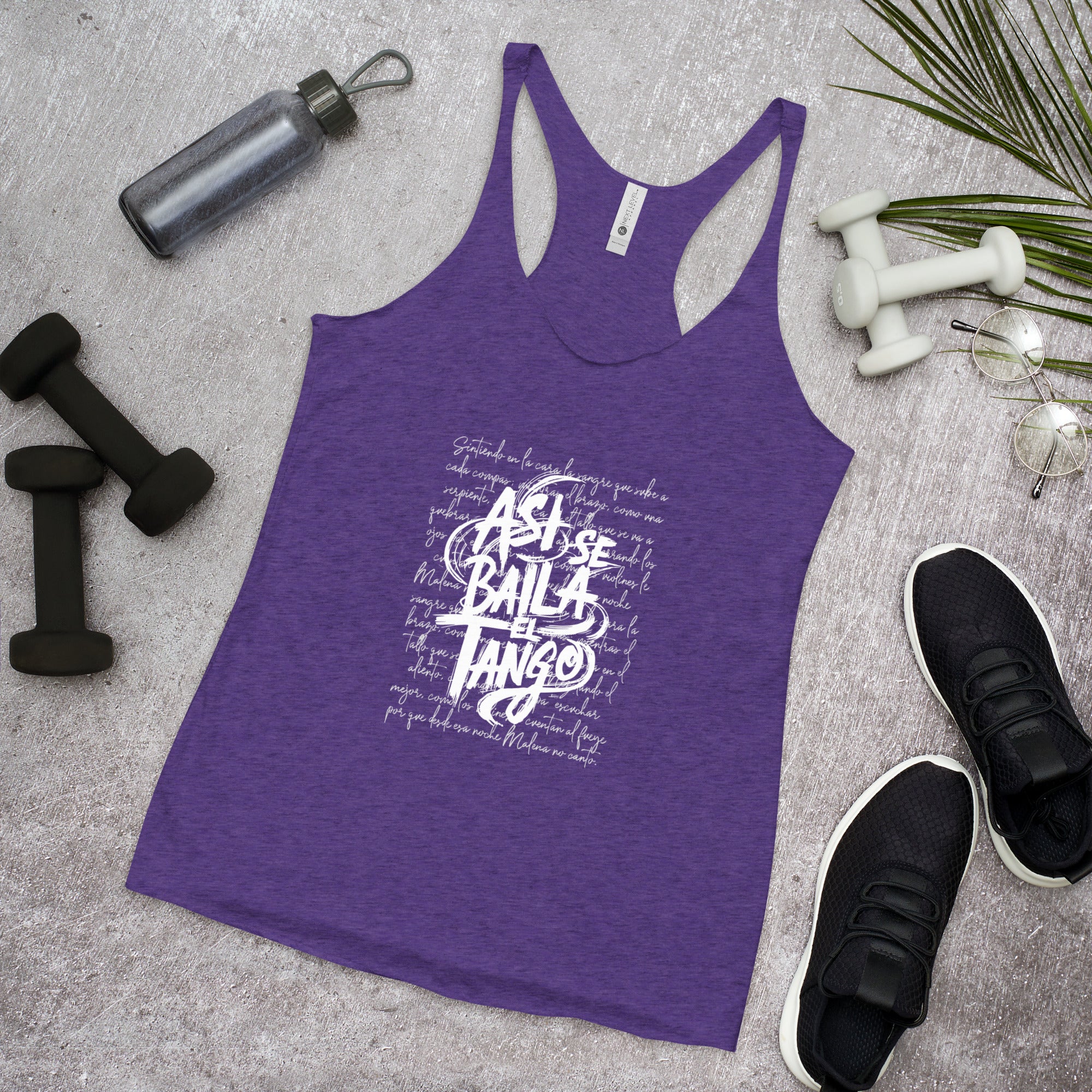 Purple tank top with white text on a gray surface with fitness items.