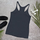 Black tank top on a concrete surface with sneakers and dumbbells.