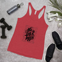 Red tank top with black text on a gray surface with fitness items.