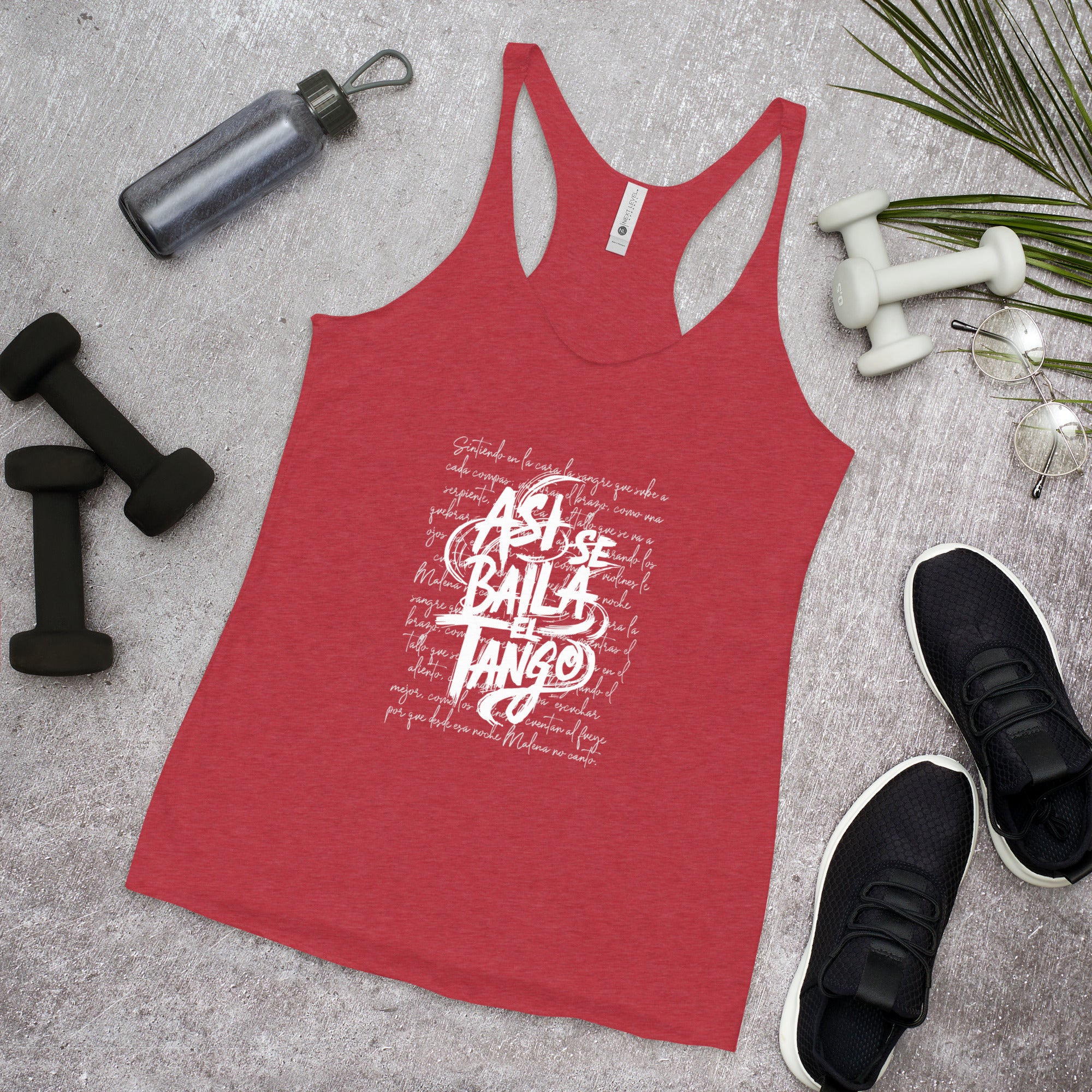 Red tank top with white text on a gray surface with fitness items.