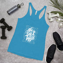 Blue tank top with white text on a gray surface with fitness items around